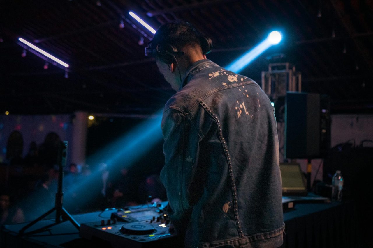 A DJ performing under stage lighting at a LIV Entertainment event