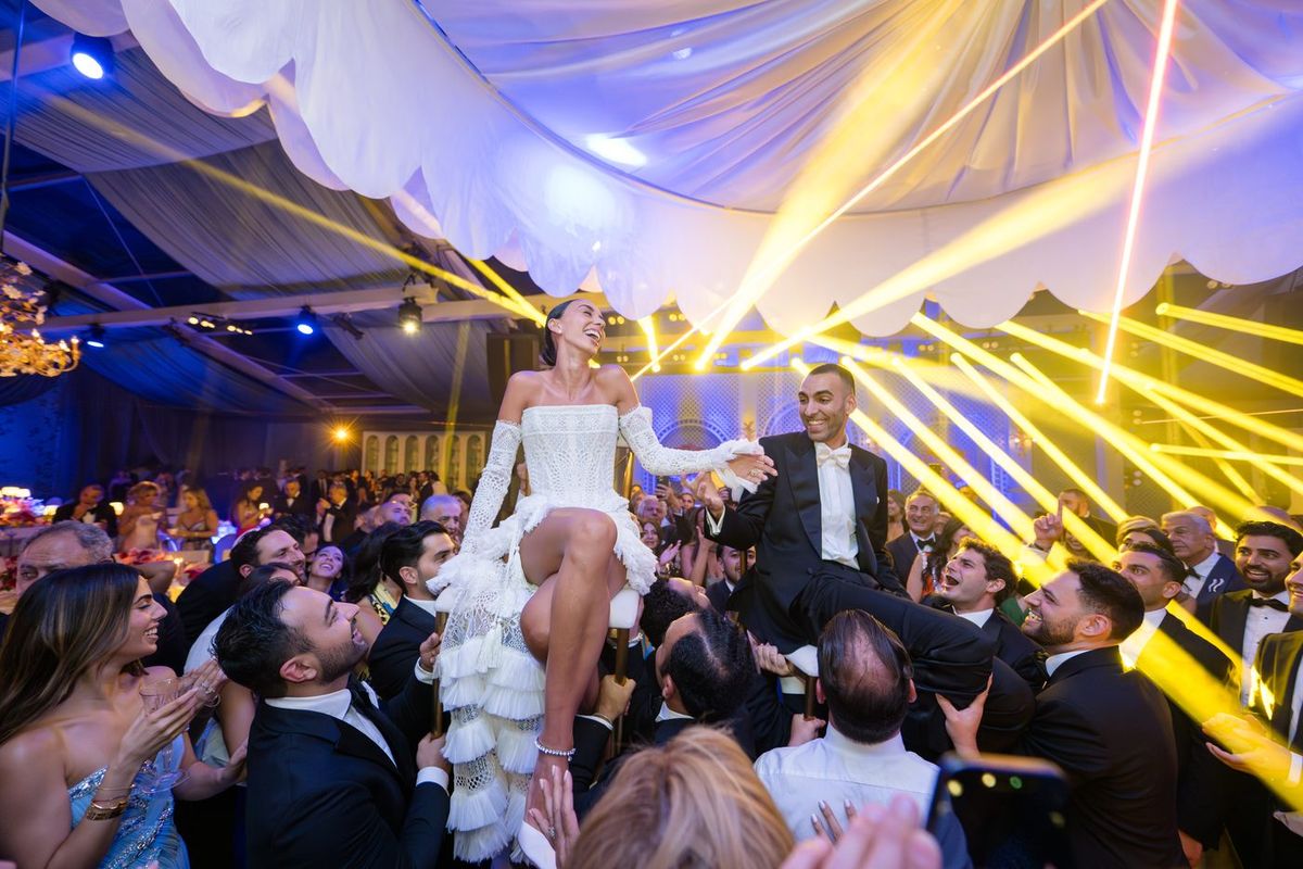 A packed dance floor under coloured lighting at a LIV event