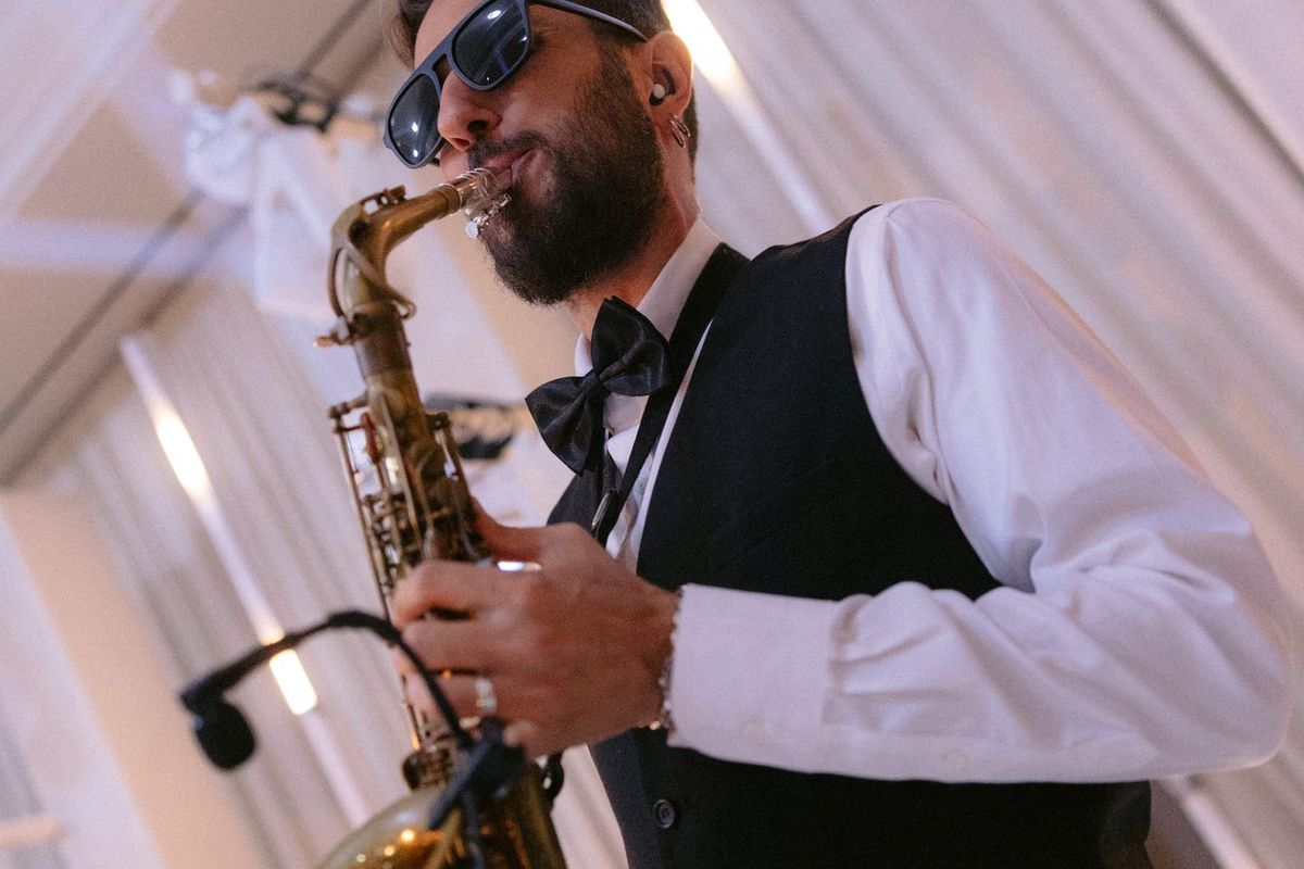 A LIV saxophonist playing at a cocktail hour