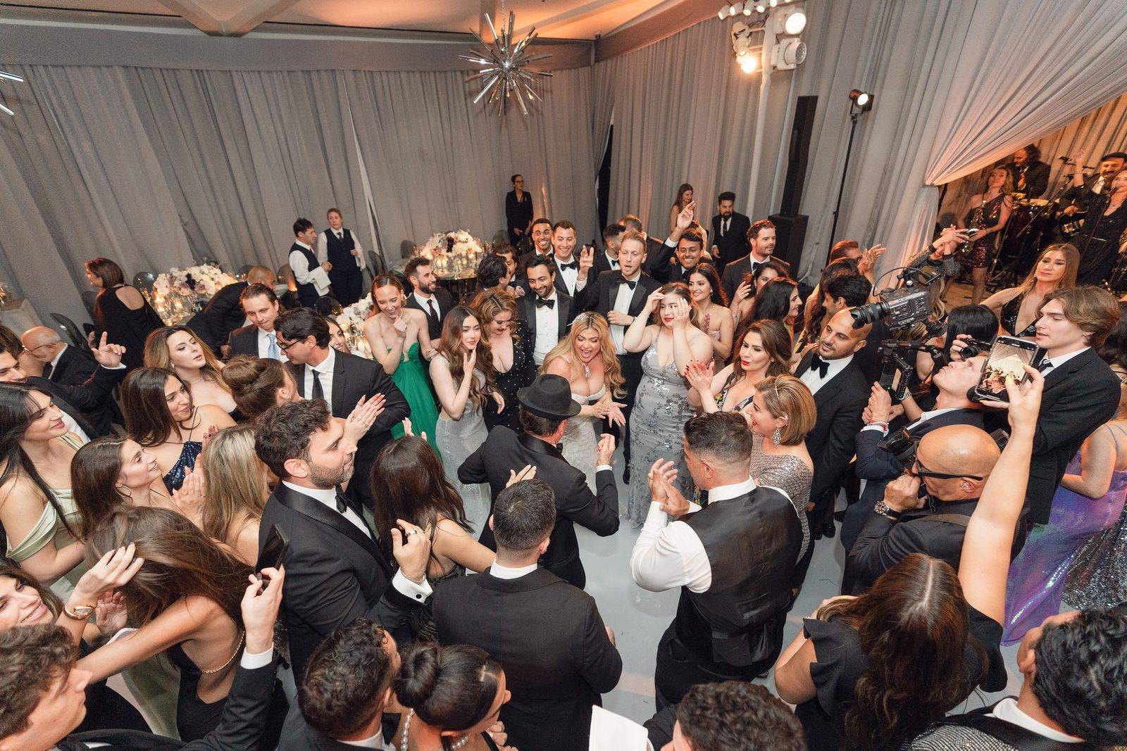 Crowded dance floor at Hotel Bel-Air photographed from above with musicians visible on the stage at the right