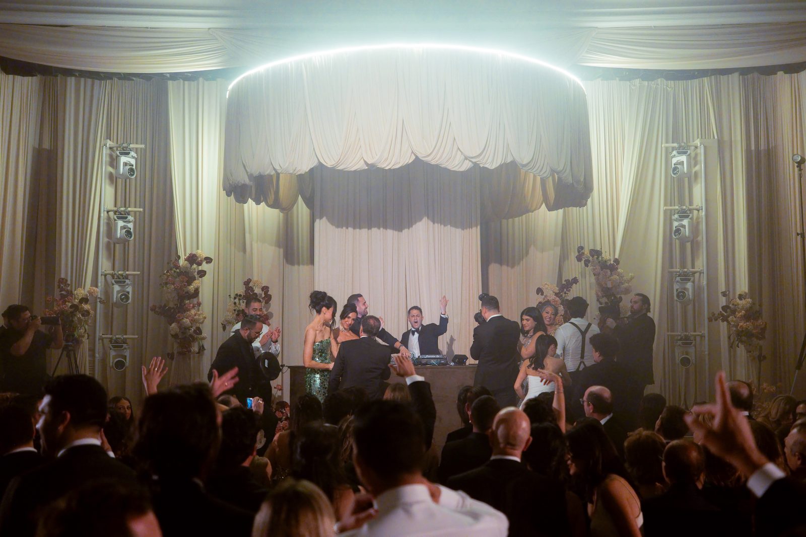 DJ playing from the stage to a full dance floor at a Beverly Wilshire wedding