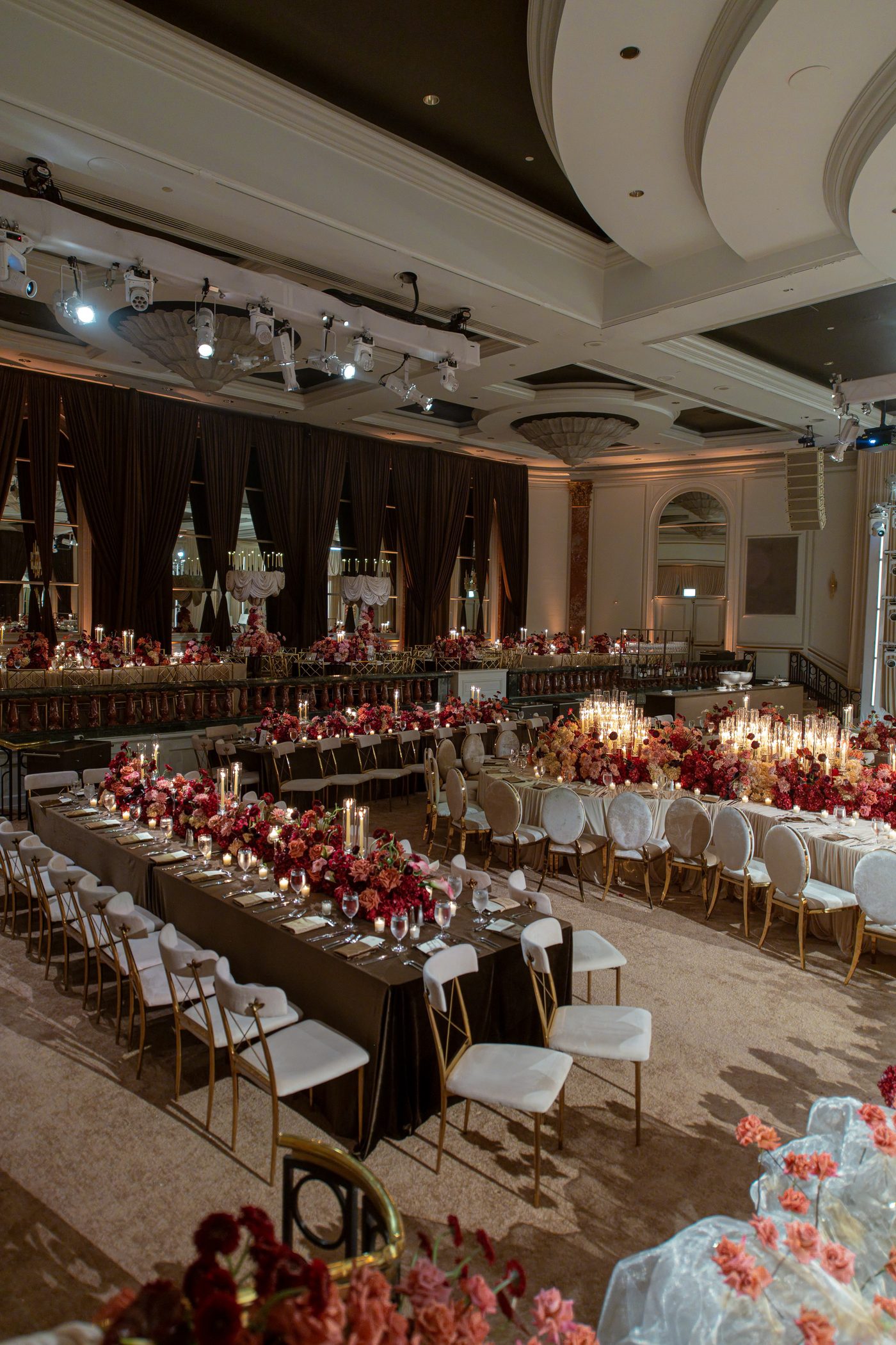 Long banquet tables and candlelight in the Beverly Wilshire ballroom under LIV Entertainment's lighting rig