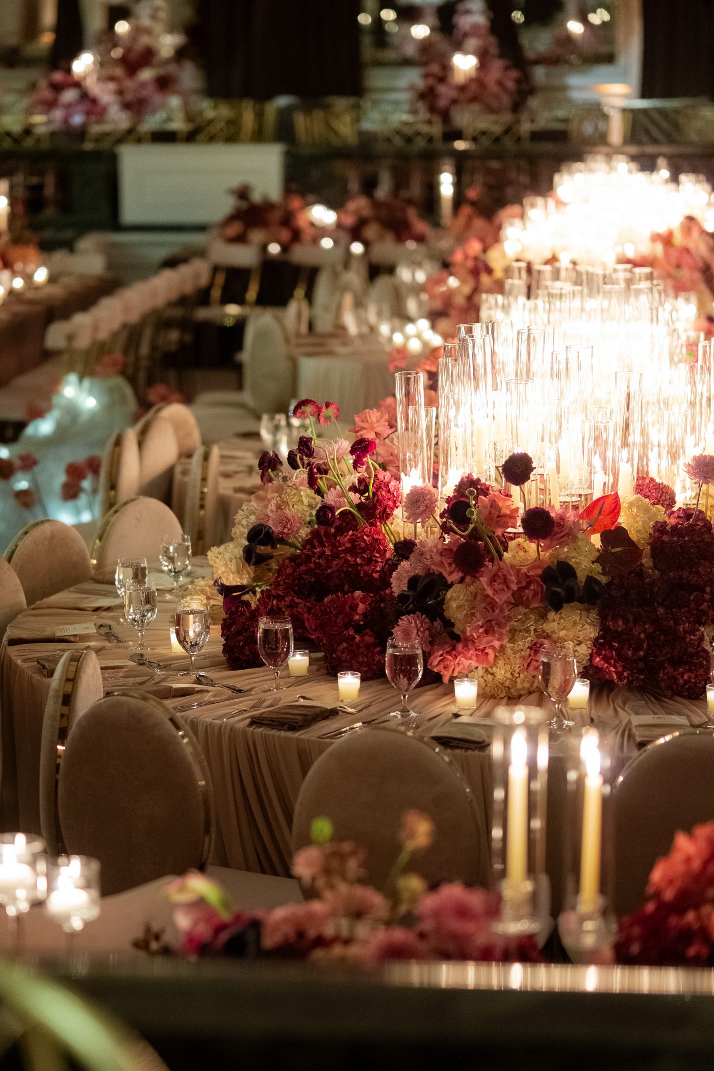 Close view of candles and layered florals on a wedding table at the Beverly Wilshire