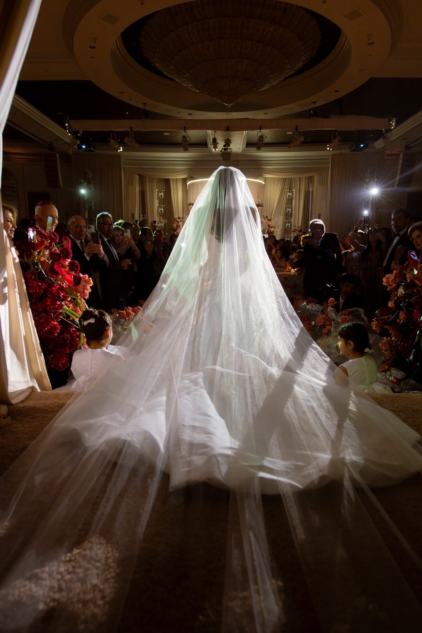 Bride walking the aisle under a single spotlight at a Beverly Wilshire wedding lit by LIV Entertainment