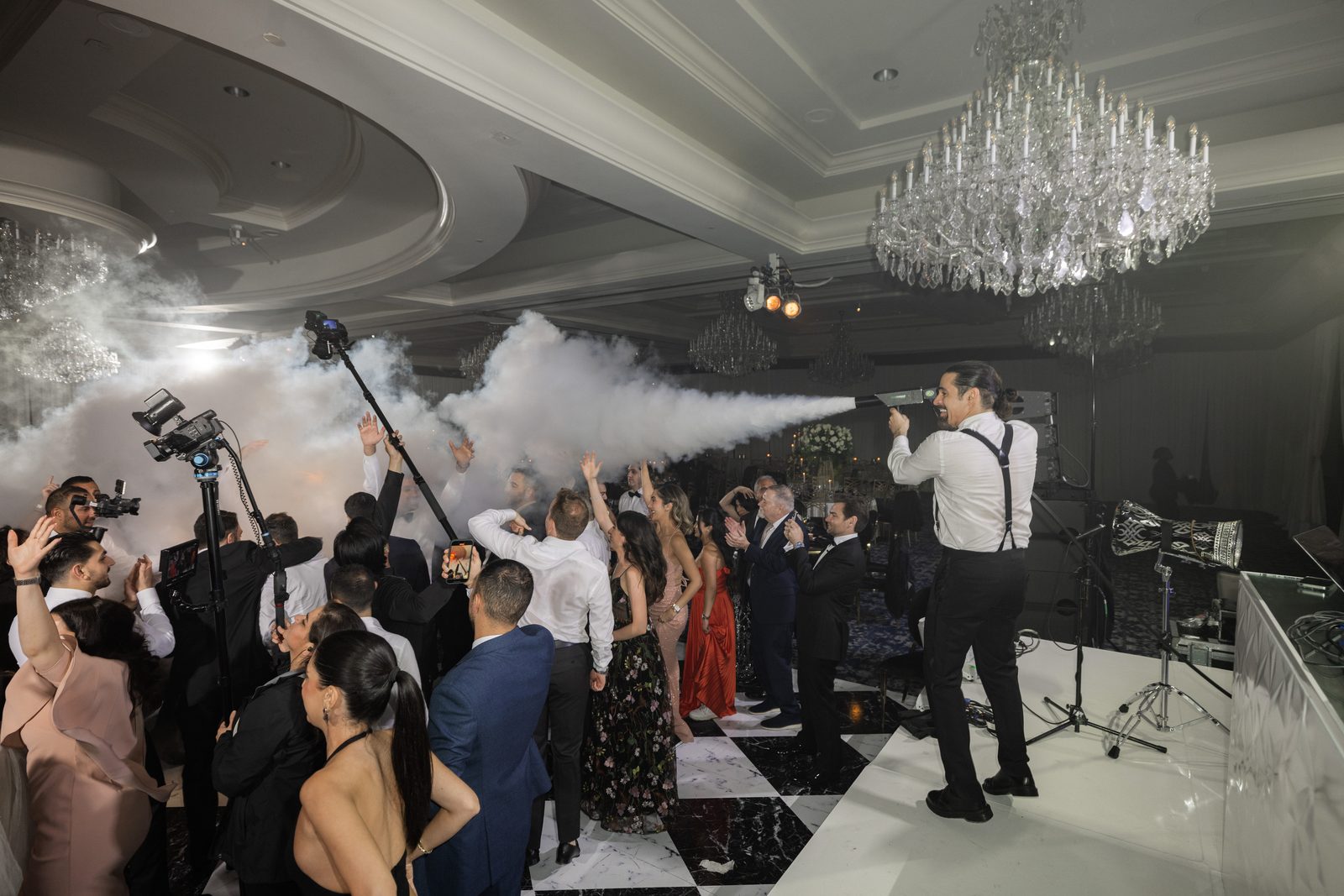 Guest firing a CO2 jet across a packed dance floor beneath the crystal chandelier at the Four Seasons Westlake Village